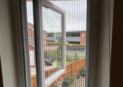 Best Fly Screens - Fly Screen fitted reveal on French double doors. The screen is fully closed.